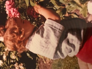 Young child standing in garden